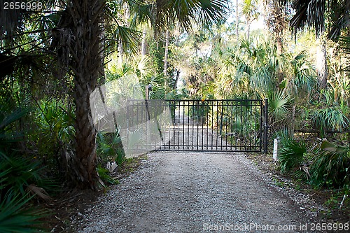 Image of closed gate on dirt road