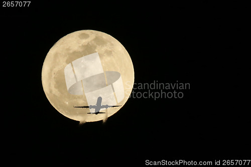Image of Jet Airplane Passing in front of a Full Moon- Real not Digitally