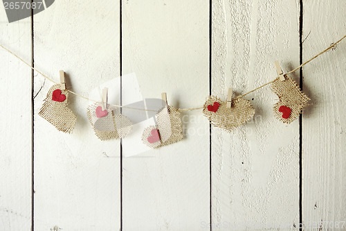 Image of Happy Valentine Burlap Hearts Hanging on a Wood Wall