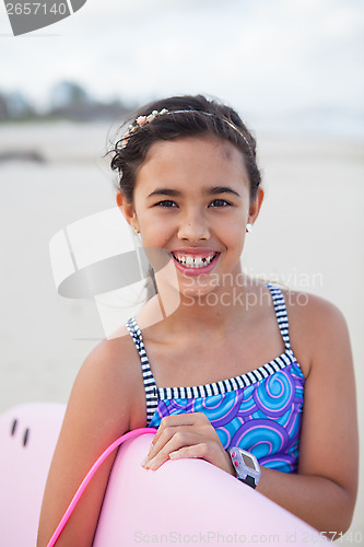 Image of Happy young girl with surfboard