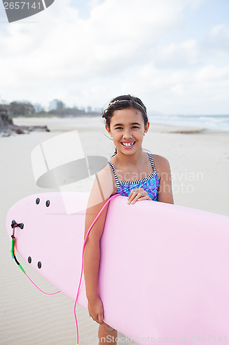 Image of Happy young girl with surfboard