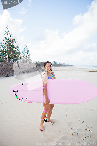 Image of Happy young girl with surfboard