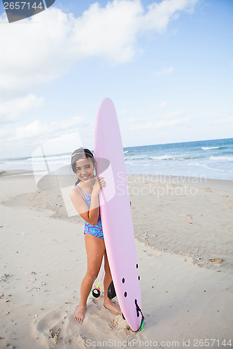 Image of Happy young girl with surfboard