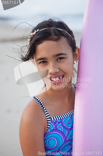 Image of Happy young girl with surfboard