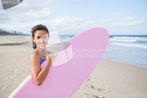 Image of Happy young girl with surfboard