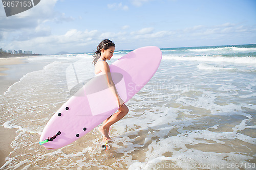 Image of Young girl with surfboard