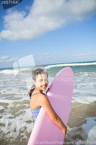 Image of Happy young girl with surfboard