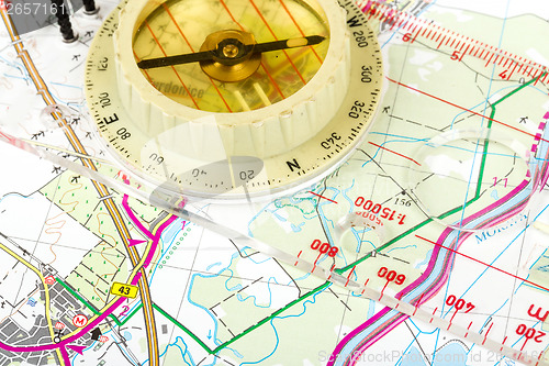 Image of old touristic compass on map