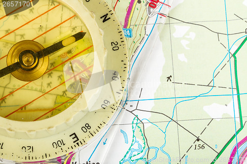Image of old touristic compass on map