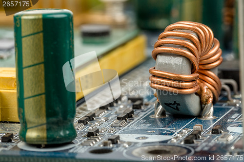 Image of computer motherboard, detail of capacitor