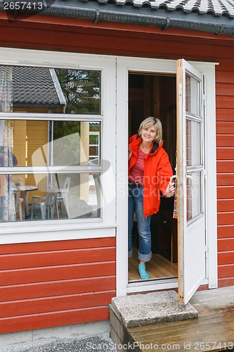 Image of Woman looking out of a cabin door