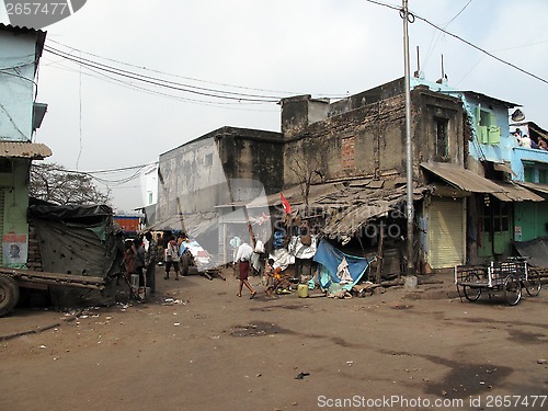 Image of Streets of Kolkata. Poor Indian family living in a makeshift shack by the side of the road