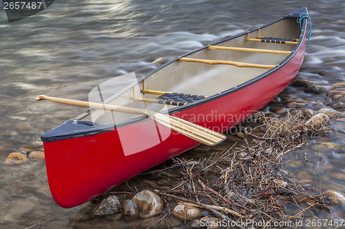 Image of red canoe with a paddle