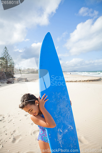 Image of Happy young girl with surfboard at beach