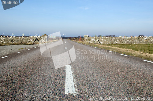 Image of Low perspective at road with windmills ahead