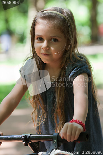 Image of Little girl riding bicycle