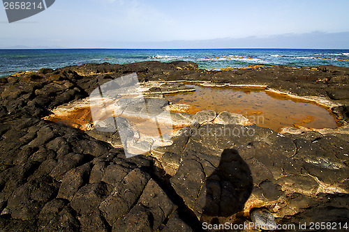 Image of in spain  lanzarote  rock stone sky cloud beach  