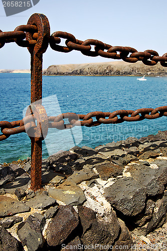 Image of rusty chain  water  boat  and sr in lanzarote spain