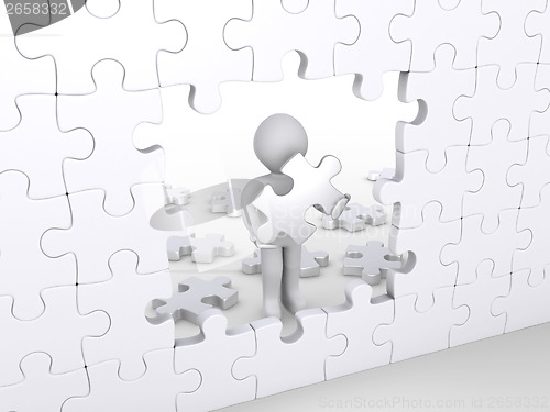 Image of Person holding puzzle piece about to complete vertical puzzle