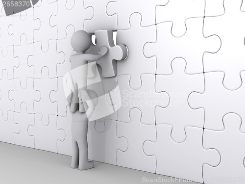 Image of Person on top of another putting last piece of puzzle