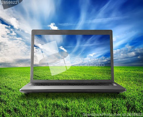 Image of Green field and laptop