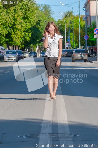Image of businesswoman walking on the road