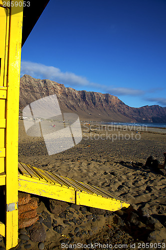 Image of lifeguard chair cabin lanzarote  rock stone sky   coastline and 