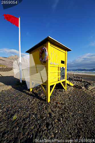 Image of lifeguard chair red flag in s  coastline and summer 