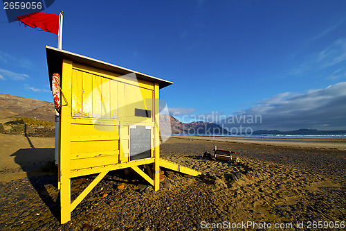 Image of water lifeguard chair cabin red flag in spain  lanzarote  rock s