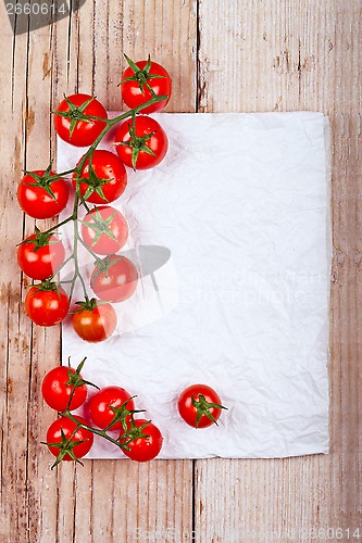 Image of fresh cherry tomatoes and piece of paper