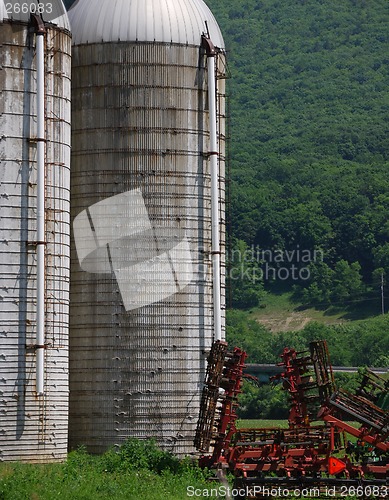 Image of Farm Silos And Crop Planting Machinery