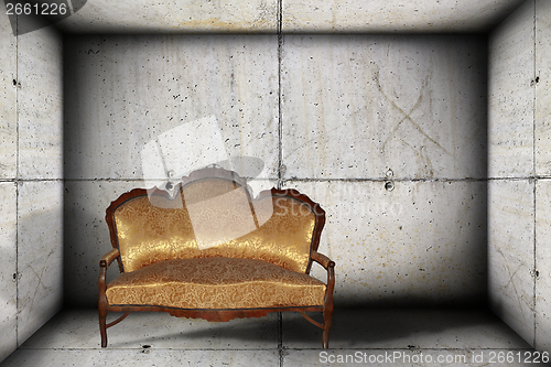 Image of sofa on concrete indoor backdrop