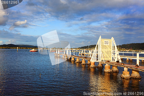 Image of Ducks relax on dilapidated old old jetty