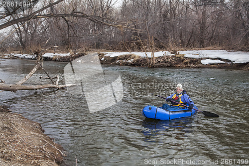 Image of paddling a packraft on a river