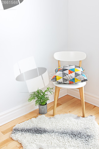Image of Chair with bright cushion and sheepskin rug on the floor