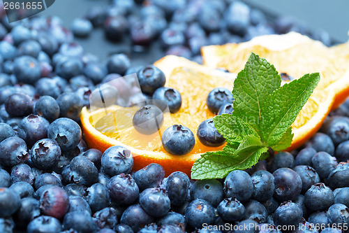 Image of Freshly picked blueberries with orange