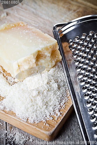 Image of grated parmesan cheese and metal grater