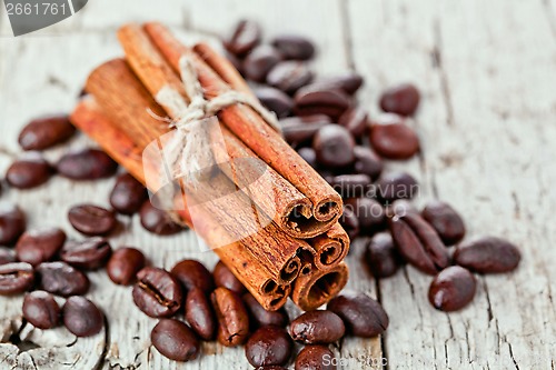 Image of stack of cinnamon sticks and coffee beans 