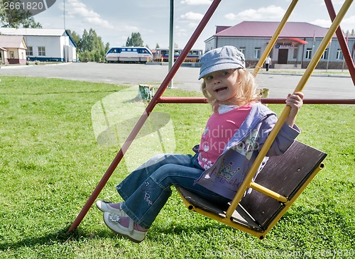 Image of Smiling girl on swing