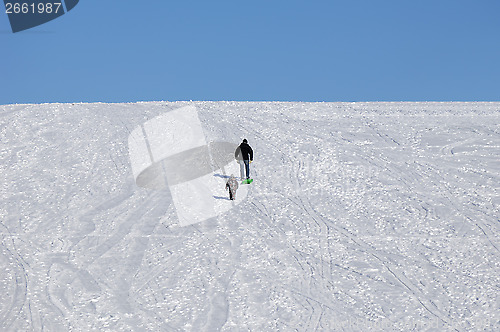 Image of People walking up hill at winter