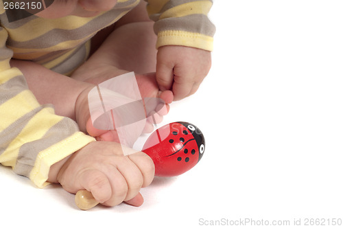 Image of Baby hand with red toy