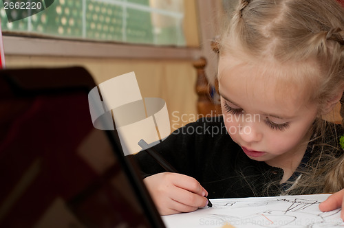 Image of Little cute girl is drawing