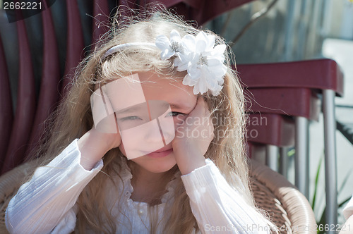 Image of Beautiful girl squinting in the sun