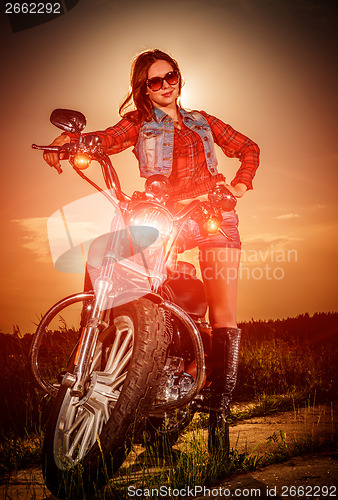 Image of Biker girl and motorcycle