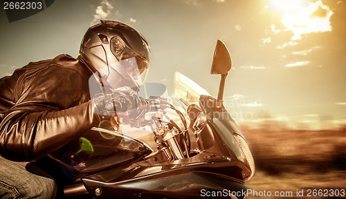 Image of Biker racing on the road