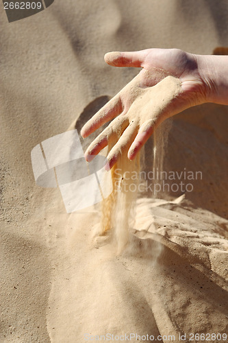 Image of Sand slipping through fingers
