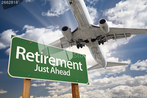 Image of Retirement Green Road Sign and Airplane Above