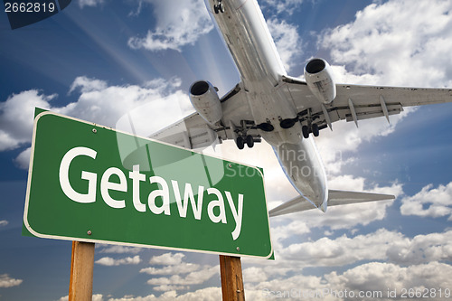 Image of Getaway Green Road Sign and Airplane Above