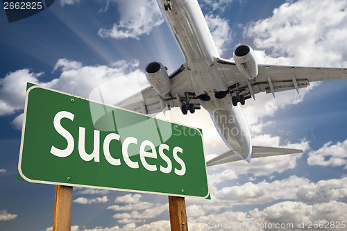 Image of Success Green Road Sign and Airplane Above
