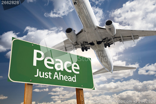 Image of Peace Green Road Sign and Airplane Above